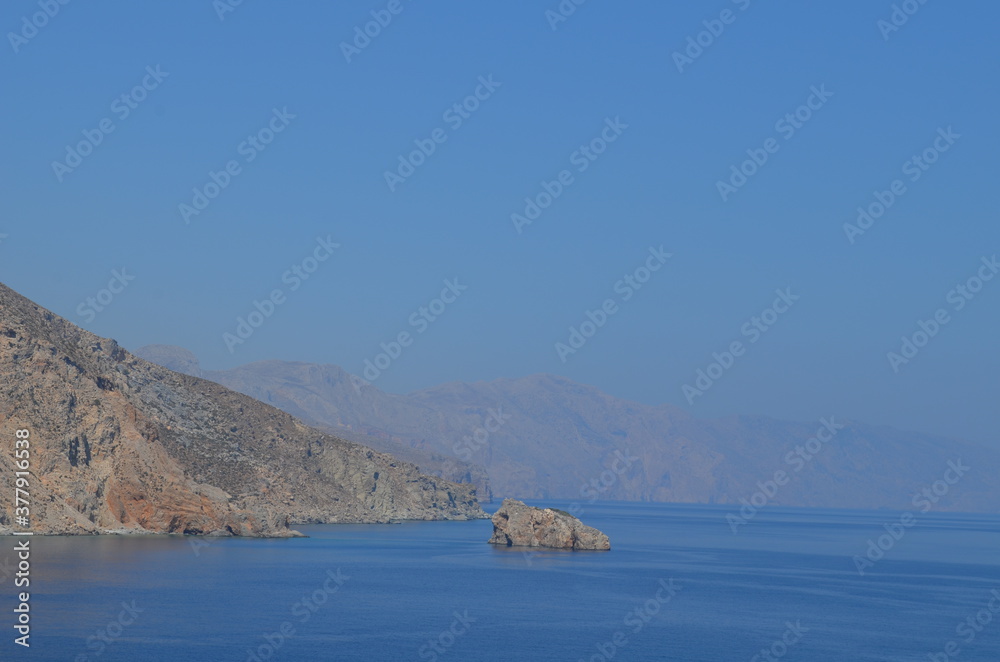 a mountain hiding in the ocean view in Greece