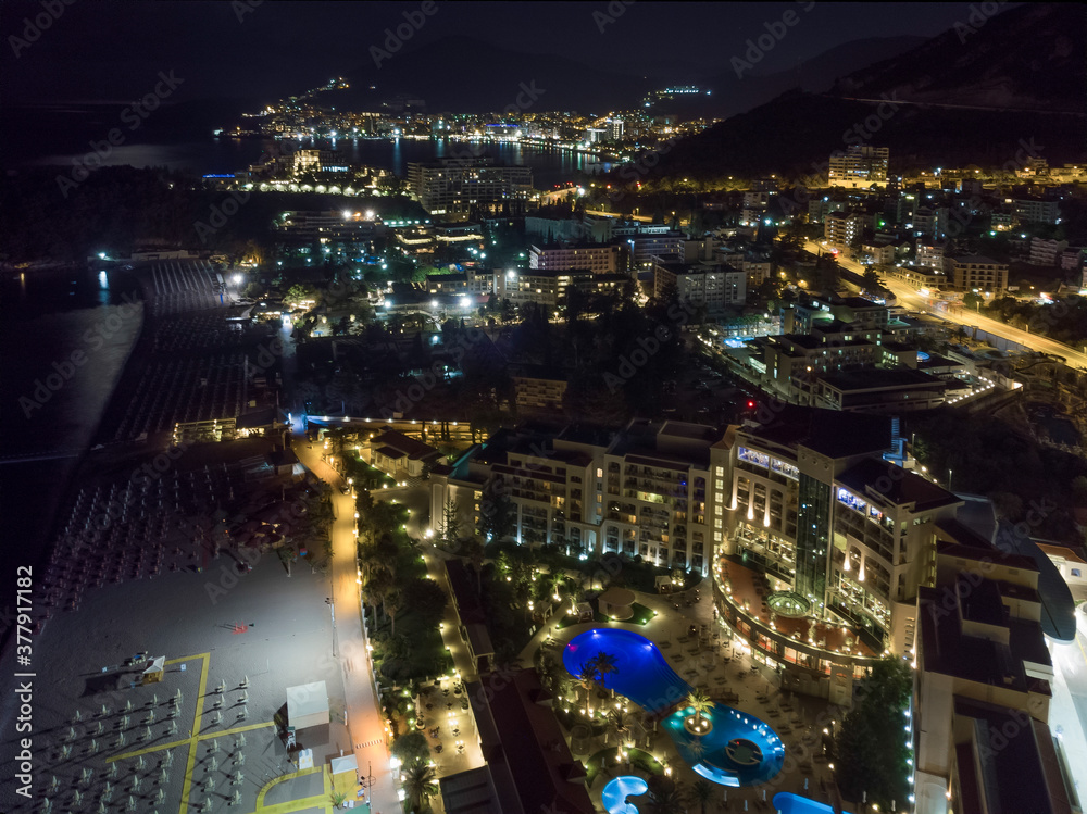 Obraz premium Budva and Becici city lights from Montenegro seen from drone. Montenegro
