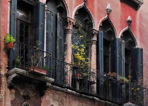 Wall of a house with old Venetian-style windows