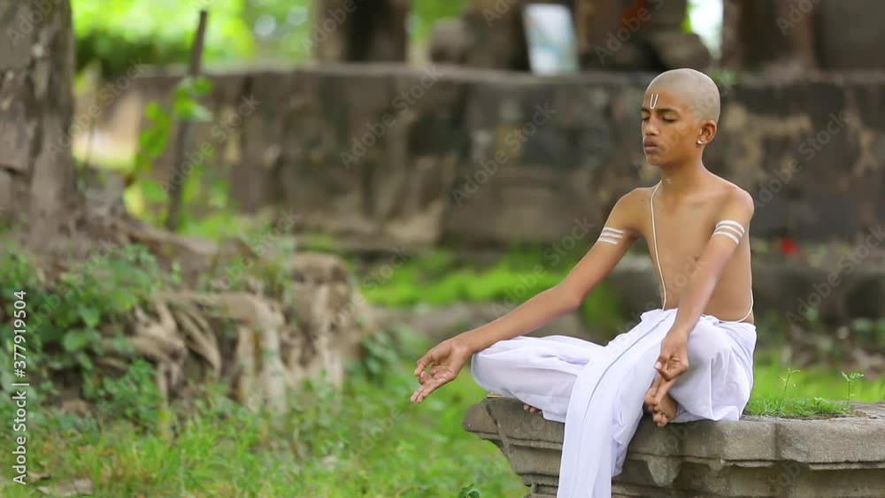 Young indian child doing yoga in the park Young indian child doing yoga in the park