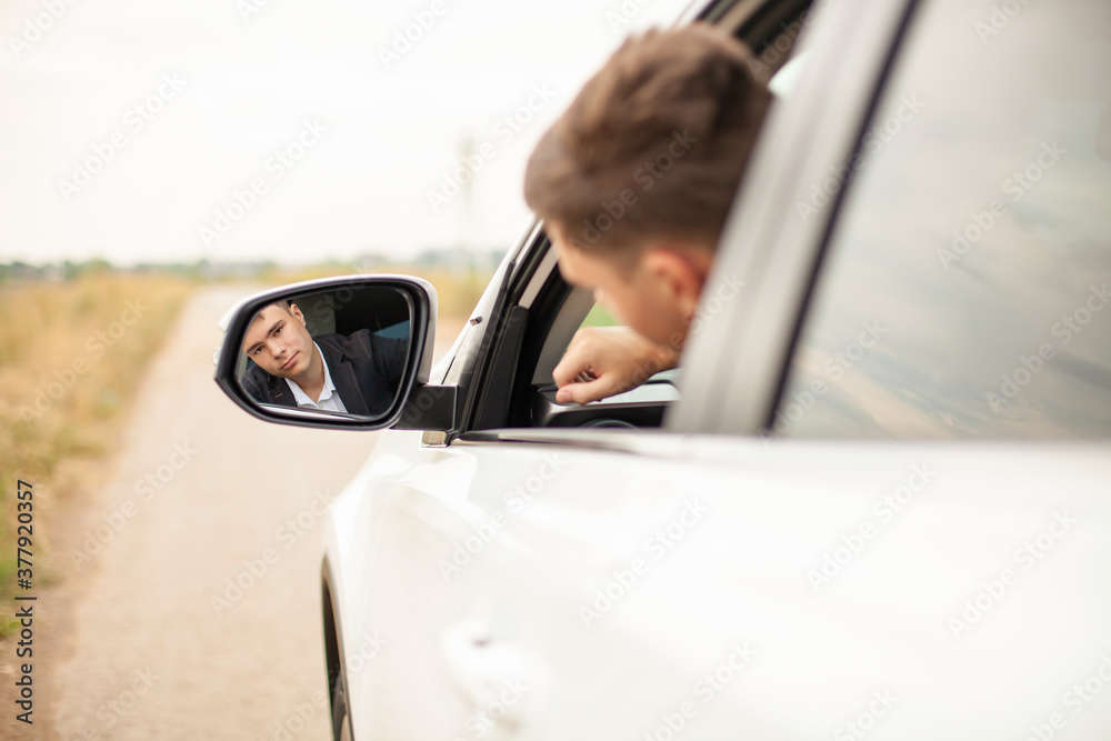 Portrait of stylish young man in the white car
Portrait of stylish young man in the white car