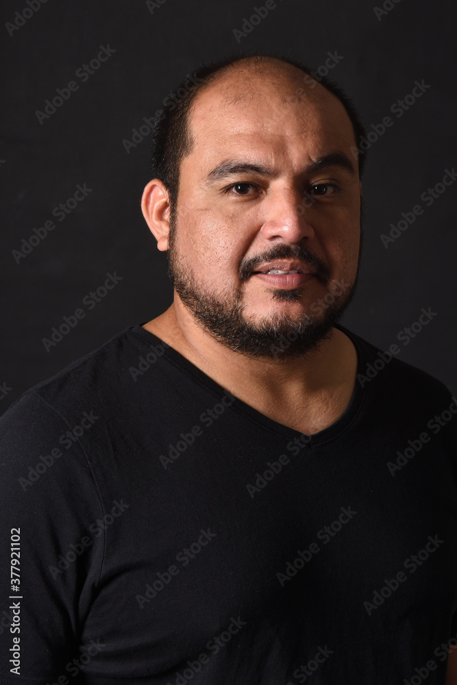portrait of a latin american man on black  background
