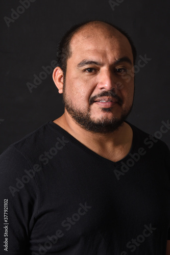 portrait of a latin american man on black background