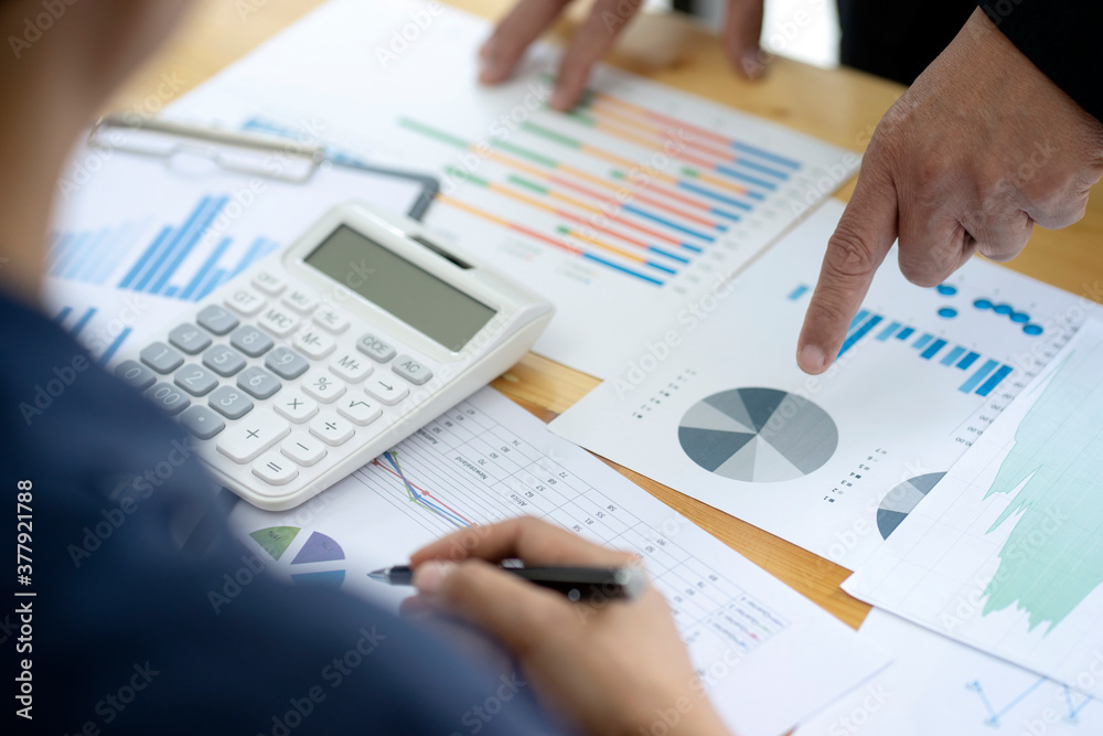 Businessman boss of the team point to graph and chart Businessman boss of the team point to graph and chart