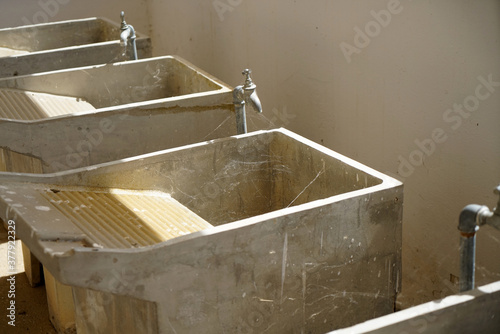 Bilde på lerret Row of old-fashioned laundry sink with washboard