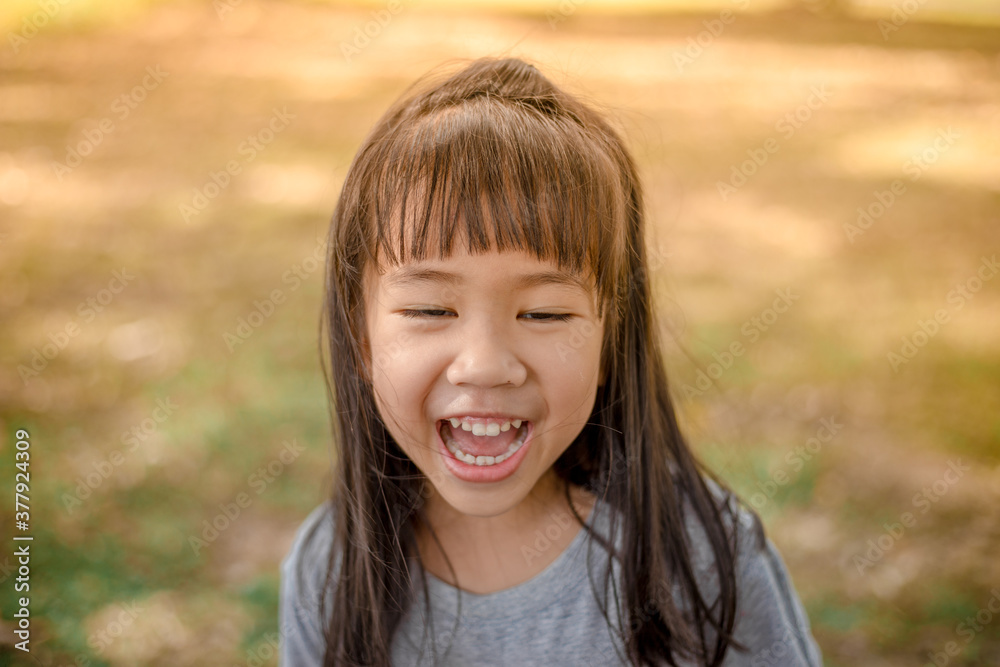 Blurred abstract background of Asian girls, cute in a bright dress, playing on the street or in a park, when parents watch closely. Blurred abstract background of Asian girls, cute in a bright dress, playing on the street or in a park, when parents watch closely.
