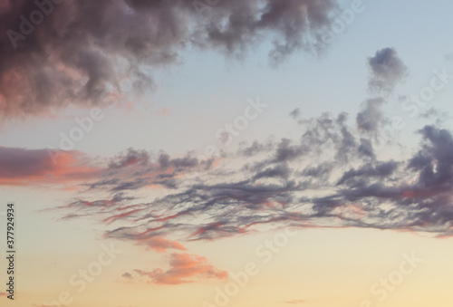 clouds at sunset against evening sky color gradient