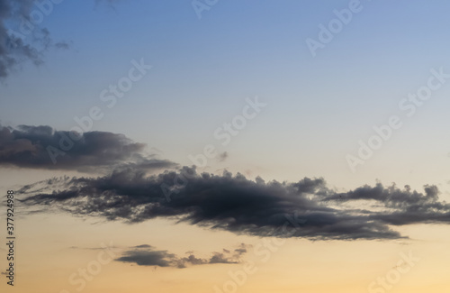 dark grey clouds against sunset sky color gradient