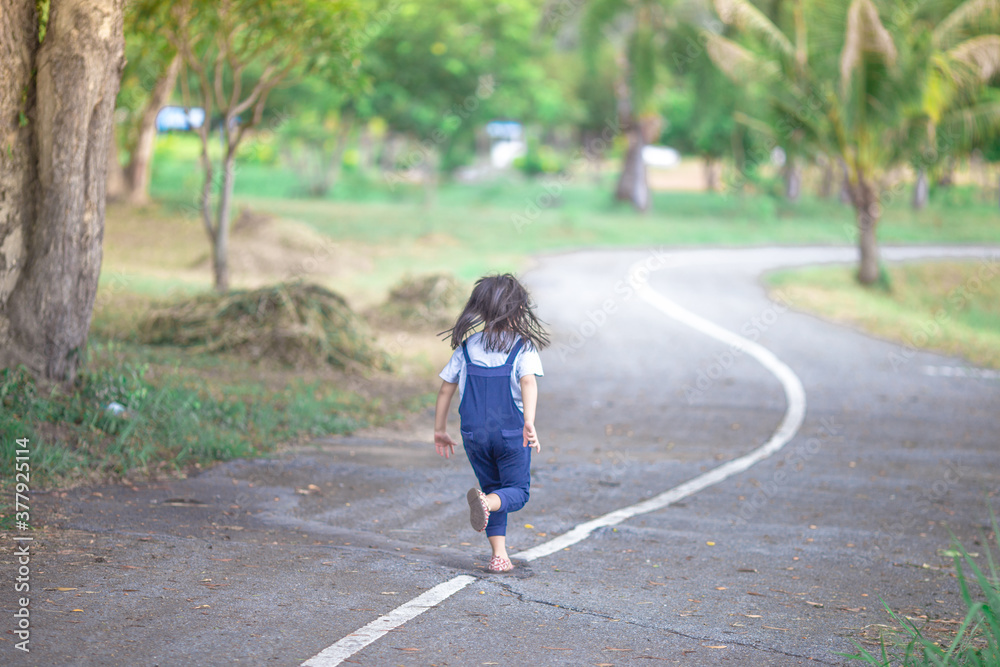 Blurred abstract background of Asian girls, cute in a bright dress, playing on the street or in a park, when parents watch closely. Blurred abstract background of Asian girls, cute in a bright dress, playing on the street or in a park, when parents watch closely.