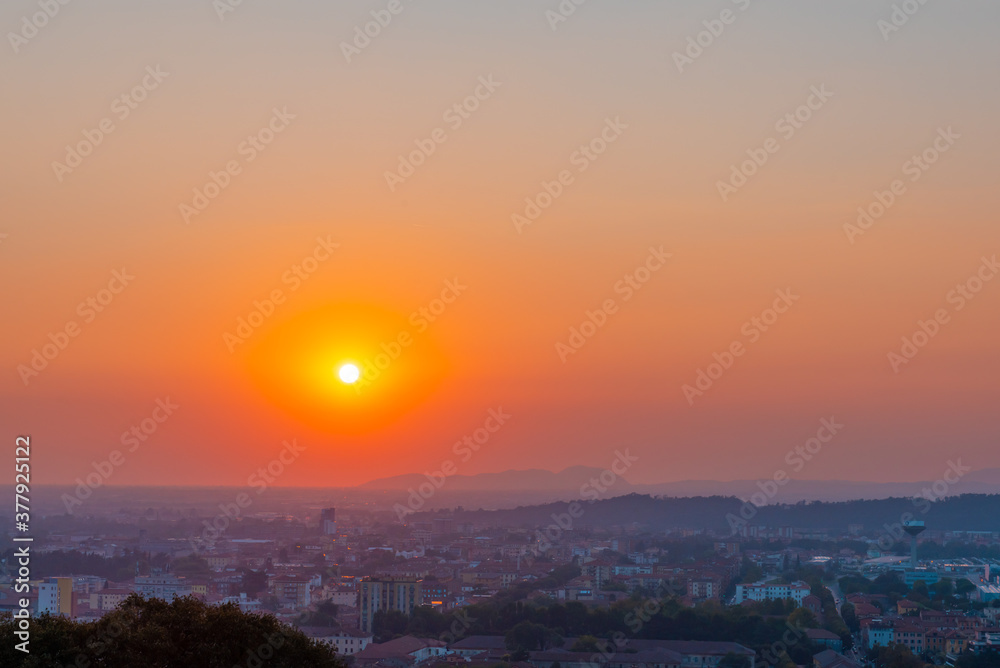 Time lapse of a sunset one hour in seven seconds. Red sunset over an urban city.