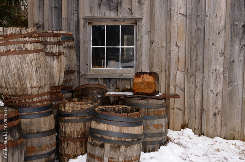 Photography Old barrels outside the cooperage in winter at Pioneer Village