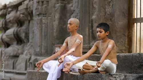 Young indian child  doing yoga in the park