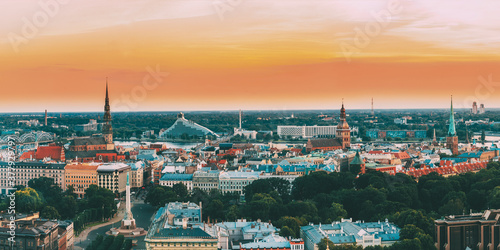 Riga  Latvia. Top View Panorama Skyline Cityscape At Sunset Light. St. Peter s Church  Boulevard Of Freedom  National Library  Dome Cathedral  Basilica Of St. James