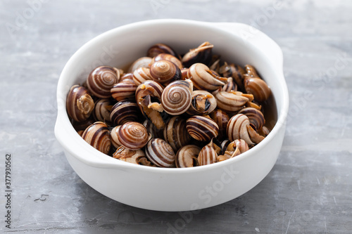 Fototapeta Naklejka Na Ścianę i Meble -  boiled snails in the white bowl on ceramic background