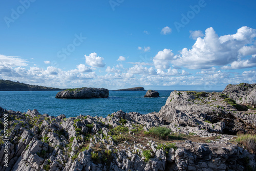 Sea, rocks and sky in Islares, Cantabria, Spain. photo