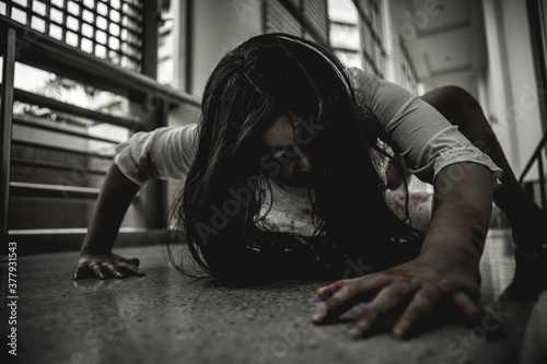 Fotografía Woman in ghost or zombie on halloween festival at dark place, holding knife and wants to stab you