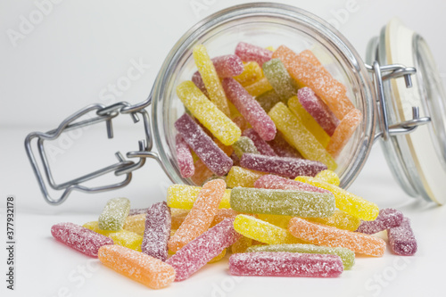 colorful sour sugar gummy candy in a glass jar