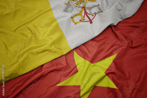 waving colorful flag of vietnam and national flag of vatican city.
