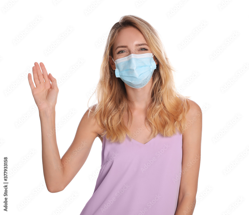 Woman in protective face mask showing hello gesture on white background. Keeping social distance during coronavirus pandemic Woman in protective face mask showing hello gesture on white background. Keeping social distance during coronavirus pandemic