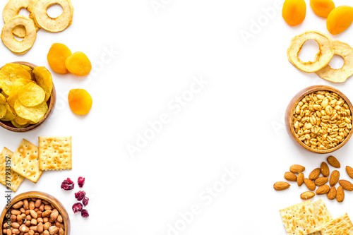 Snacks mix frame top view. Nuts and dried fruits with crackers, copy space