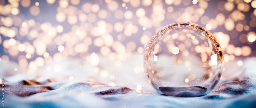 Christmas glass ball on snow. Glitter lights - obrazy, fototapety, plakaty 