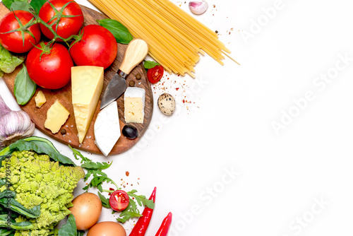 Mediterranean food background. Frame made of cheese, pasta, tomatoes, Romanesco cauliflower, herbs and spices on a white background, top view. Free space for text. Italian Cuisine.