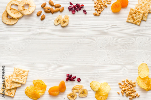 Frame of nuts overhead with dried fruits and other snacks top view
