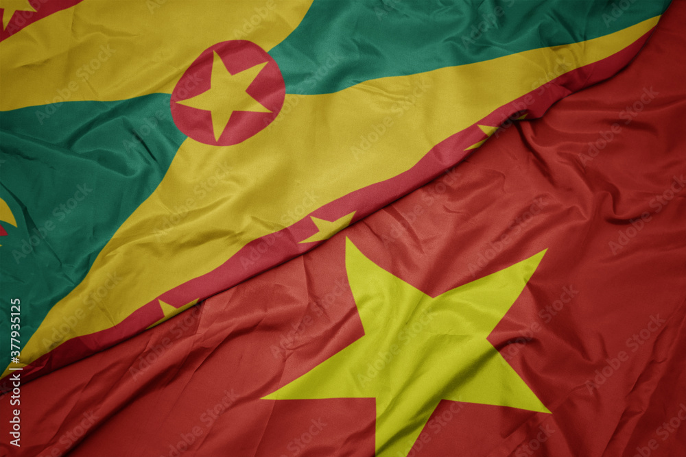 waving colorful flag of vietnam and national flag of grenada. waving colorful flag of vietnam and national flag of grenada.