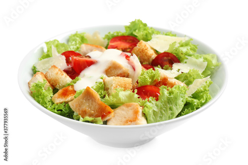 Delicious fresh Caesar salad in bowl on white background