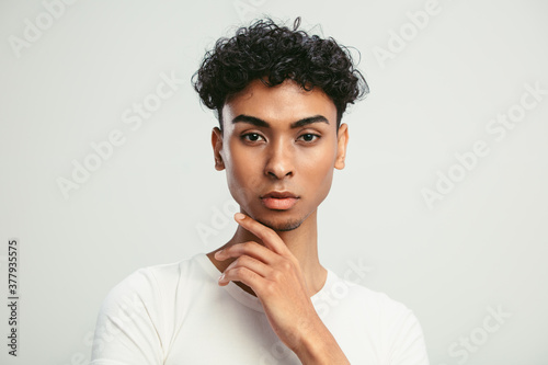 Portrait of an androgynous man on white background