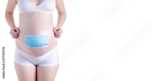 pregnant woman belly medical mask on white background isolation, pandemic virus