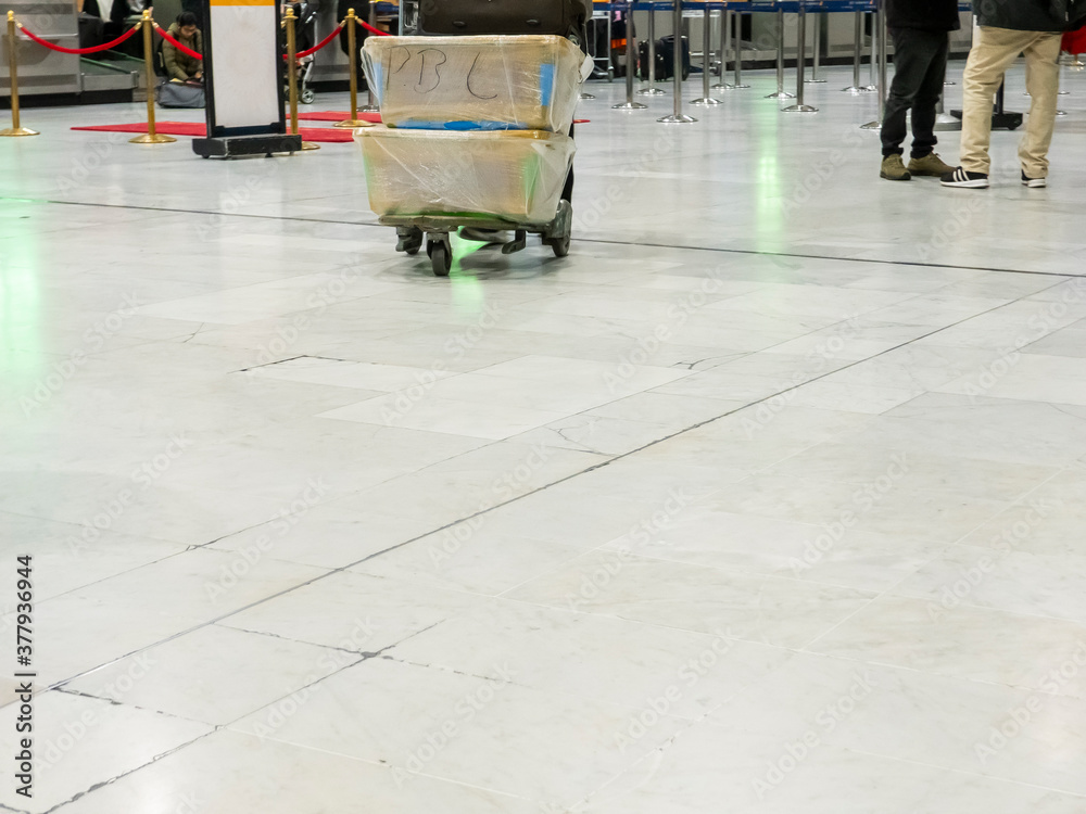 Obraz premium few traveler with travel suitcase luggage walking in airport terminal hall walkway for vacation business concept vacationing travel. Social distancing during coronavirus