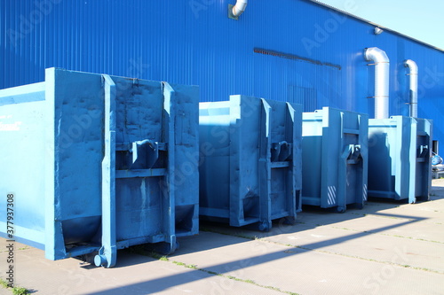Blue waste containers in a large hangar