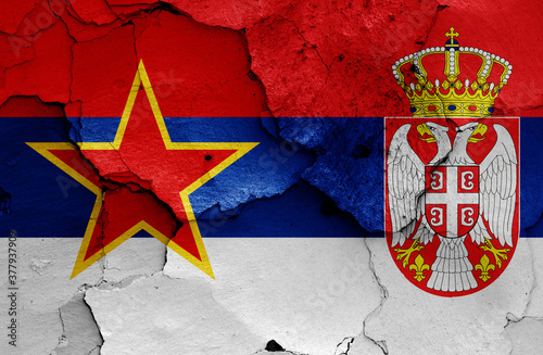 historical flag of Socialist Republic of Serbia and today Serbia flag on cracked wall photo