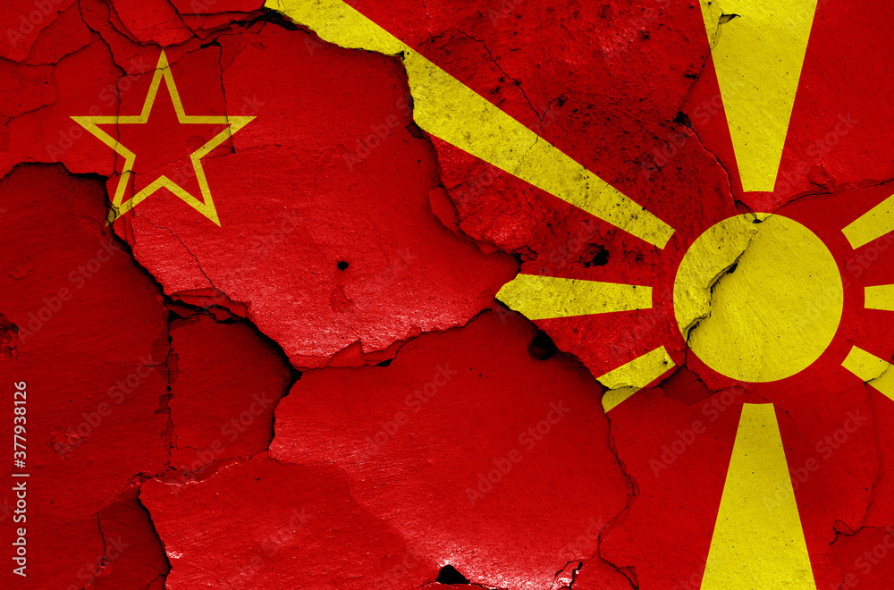 historical flag of Socialist Republic of Macedonia and today North Macedonia flag painted on cracked wall