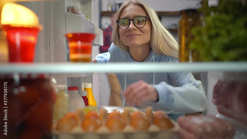Young hipster woman looking inside fridge searching for snack Young hipster woman looking inside fridge searching for snack