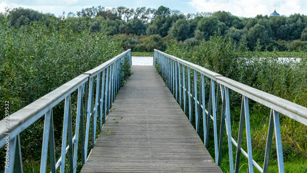 Fototapeta premium wooden bridge leading to the river