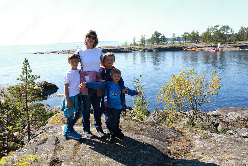 Mother with sons on island in Ladoga skerries Mother with sons on island in Ladoga skerries