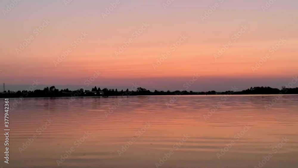 Haze and smoke filled skies causing layers of red and purple layers reflecting over a calm lake. California wildfires. Mountain View, California (USA). Haze and smoke filled skies causing layers of red and purple layers reflecting over a calm lake. California wildfires. Mountain View, California (USA).