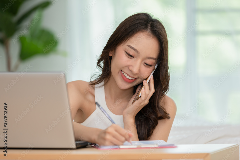 Business Startup of Young Asian women working with laptop for Online shopping at home and talking with customer to delivery order Business Startup of Young Asian women working with laptop for Online shopping at home and talking with customer to delivery order