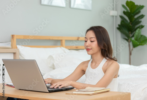 Beautiful Attractive Asian indian woman working with computer laptop and thinking to get ideas and requirement in Business startup at home feeling so happiness,Business Startup Concept