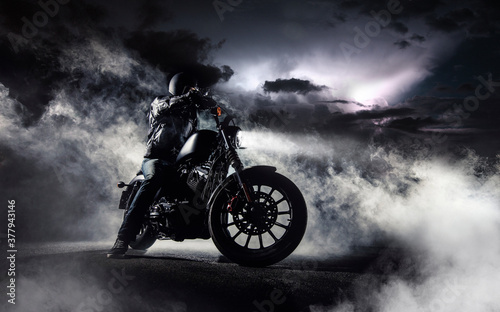 Canvas Print Detail of high power motorcycle chopper with man rider at night.