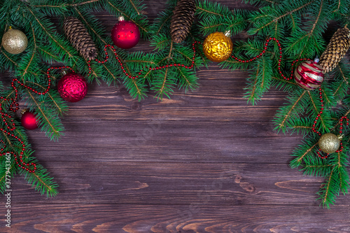 Christmas tree with decoration on a dark wooden background. View from above. Place for an inscription. New Year. Christmas