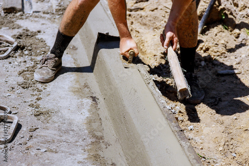 Fotografie Installation of concrete curb for a convenient pedestrian crossing