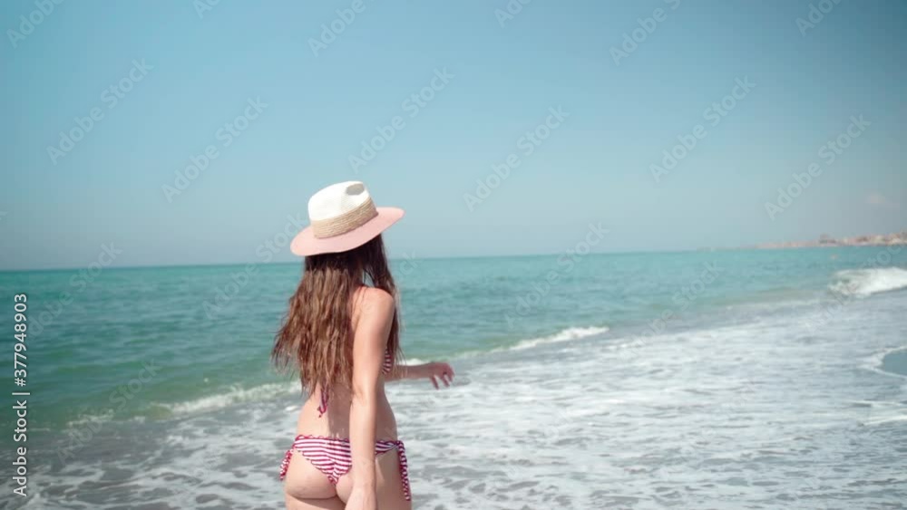 Problem of cellulite on woman's buttocks, overweight and unhealthy eating. Pretty young female in sexy bikini walking along the sea beach in slow motion, feminine body in good shape. Beautiful woman Problem of cellulite on woman's buttocks, overweight and unhealthy eating. Pretty young female in sexy bikini walking along the sea beach in slow motion, feminine body in good shape. Beautiful woman