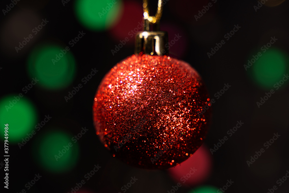 Fototapeta premium Red christmas ball on blur background.Bokeh background