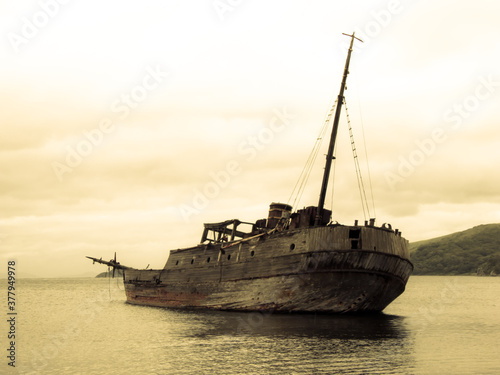 Old whaler on the sea background photo