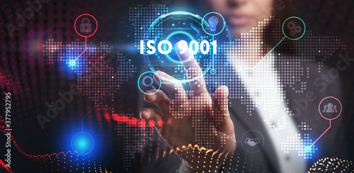 Business, Technology, Internet and network concept. Young businessman working on a virtual screen of the future and sees the inscription: ISO 9001