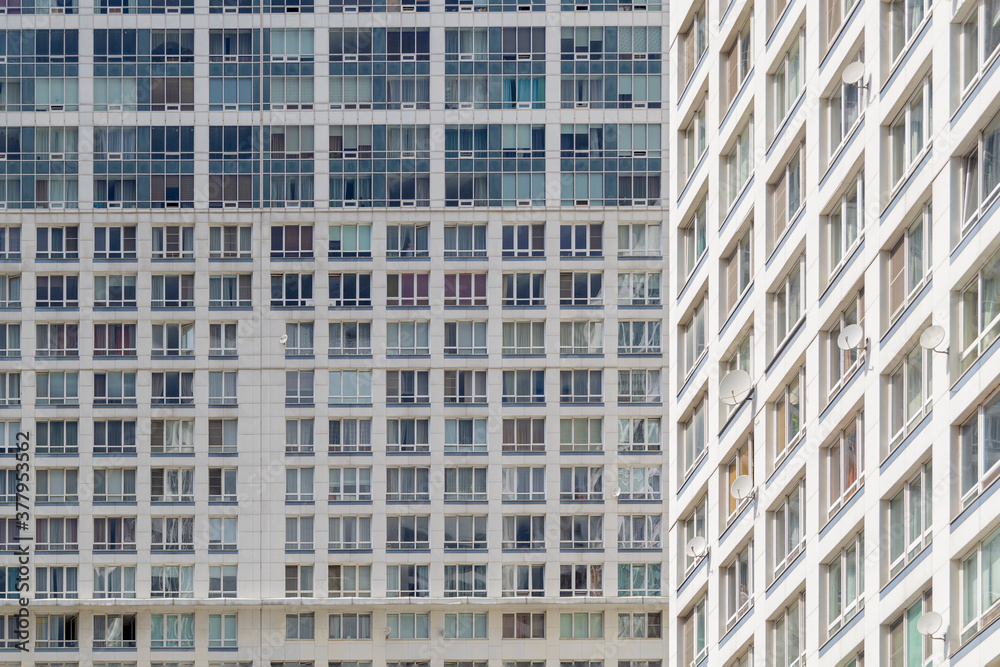 Building facades with many glazed balconies and windows. Abstract geometrical view of part of new modern residential building. Perspective view from below. Building facades with many glazed balconies and windows. Abstract geometrical view of part of new modern residential building. Perspective view from below.