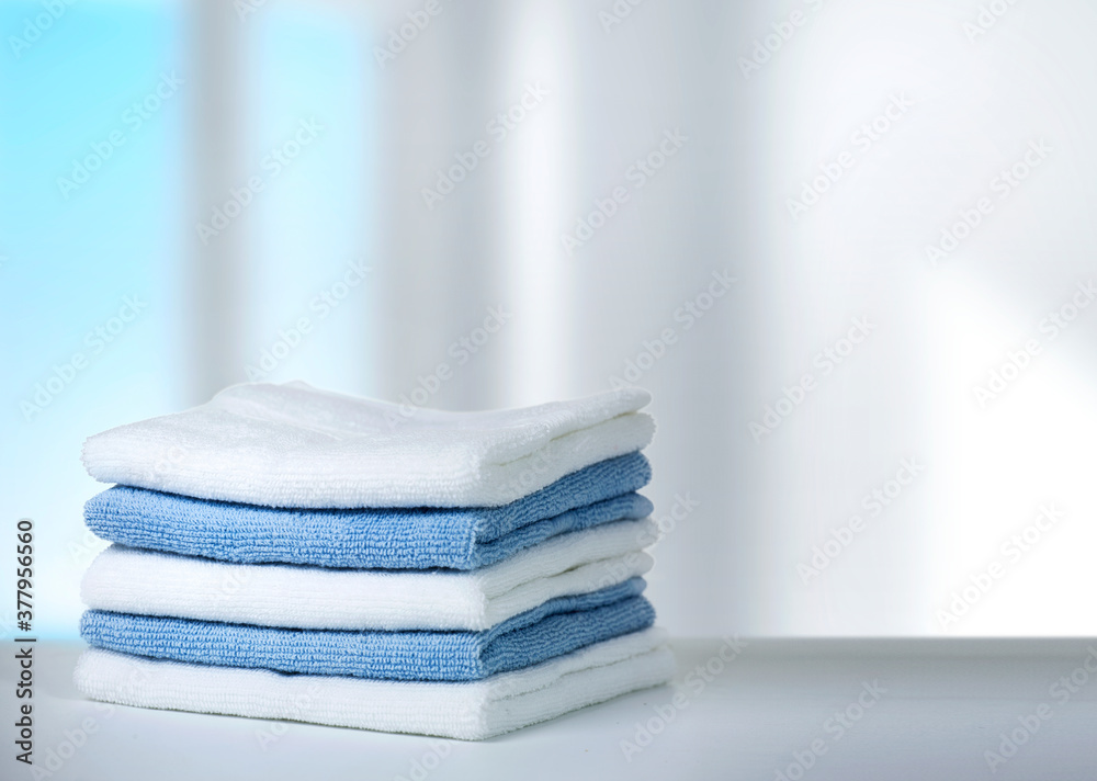 Stack of towels on table,household and laundry. - obrazy, fototapety, plakaty 